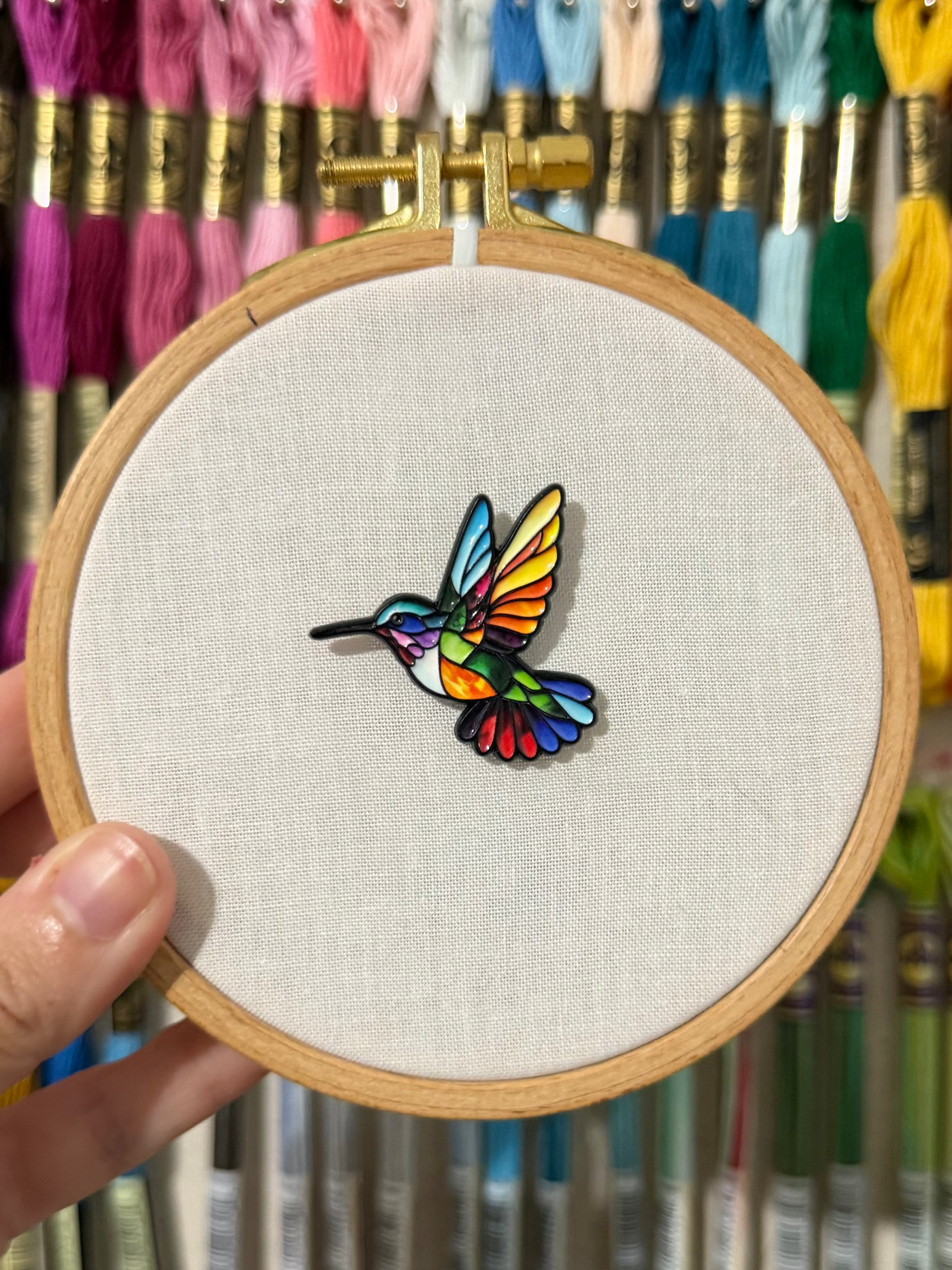 Stained glass hummingbird soft enamel needle minder on a 100mm embroidery hoop